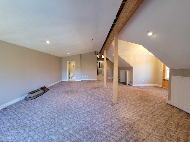 interior space featuring carpet floors and lofted ceiling