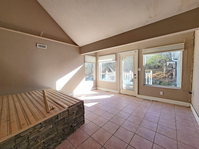 interior space with high vaulted ceiling, light tile patterned floors, and a wealth of natural light