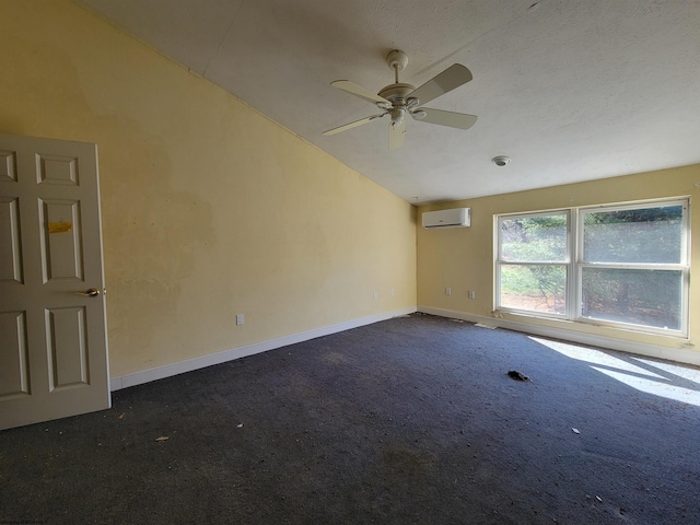 unfurnished room featuring a wall mounted air conditioner, a textured ceiling, vaulted ceiling, ceiling fan, and dark colored carpet