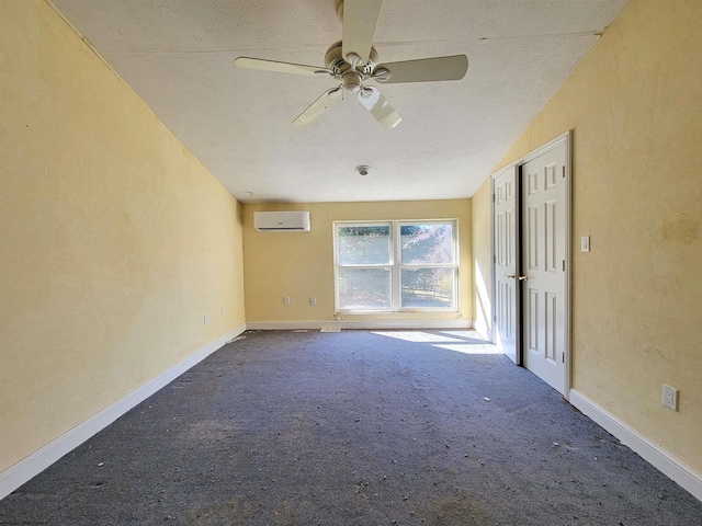 carpeted spare room with a wall mounted air conditioner, a textured ceiling, ceiling fan, and lofted ceiling