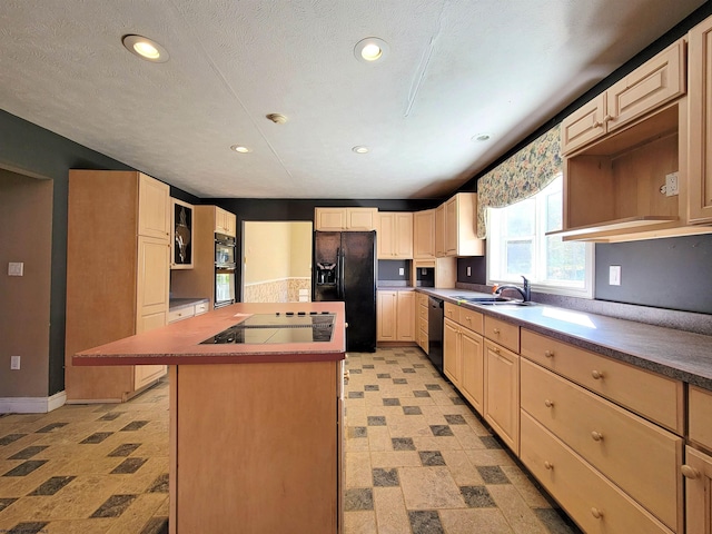 kitchen with sink, a kitchen island, black appliances, and a textured ceiling