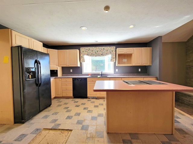 kitchen with sink, a kitchen island, and black appliances