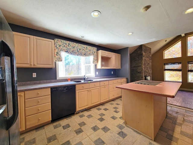 kitchen with black appliances, a kitchen island, sink, and light brown cabinets