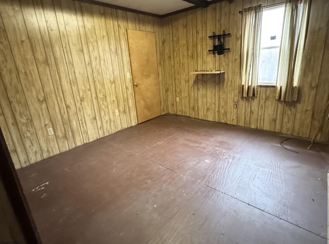 spare room featuring wood walls