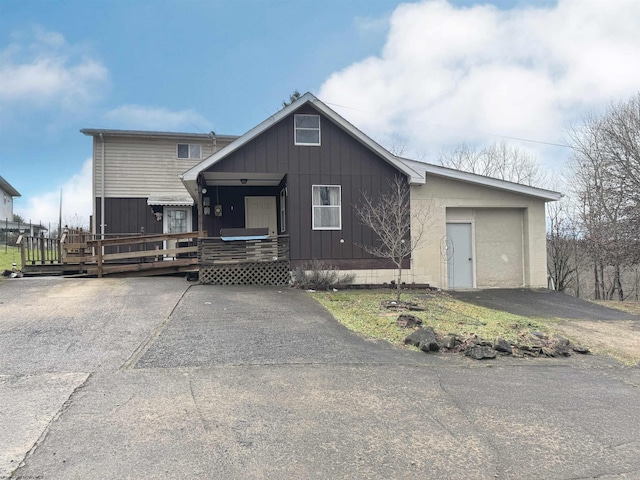 view of front of house with a wooden deck and a garage