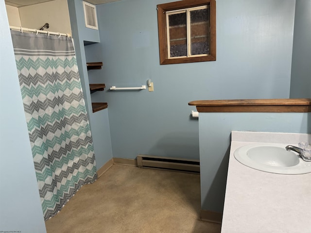 bathroom with a shower with curtain, vanity, and a baseboard heating unit