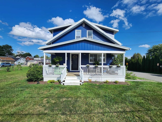 view of front of property with covered porch and a front yard