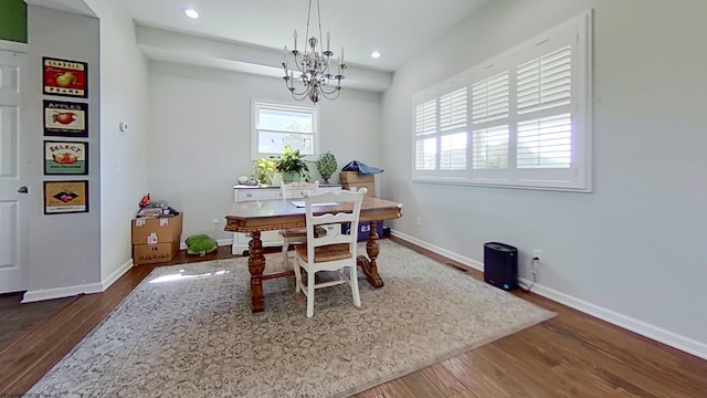 dining room with a chandelier and dark hardwood / wood-style floors