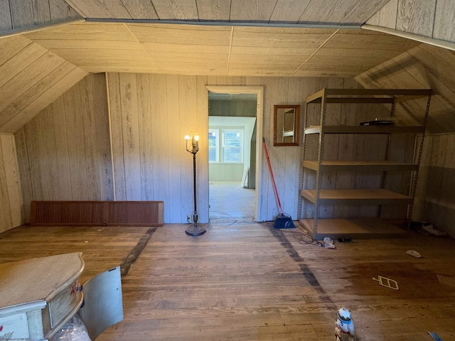 bonus room with dark hardwood / wood-style flooring, wood ceiling, wooden walls, and vaulted ceiling