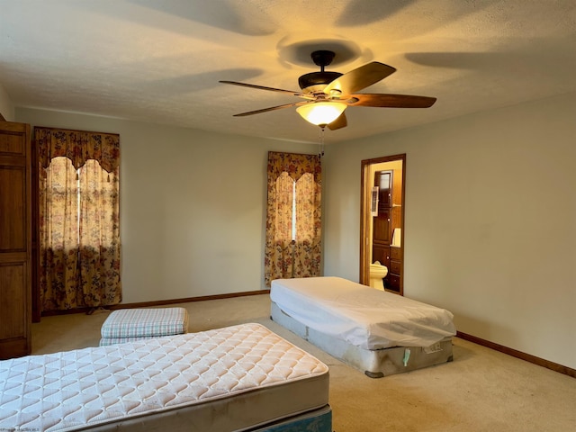 bedroom featuring ceiling fan, a textured ceiling, and light carpet