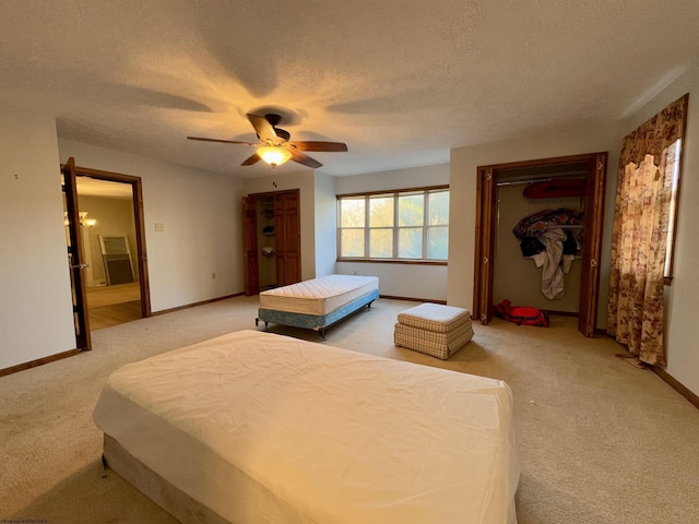 carpeted bedroom featuring a textured ceiling and ceiling fan