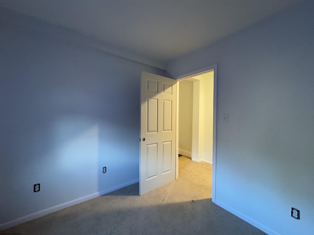 spare room with light carpet