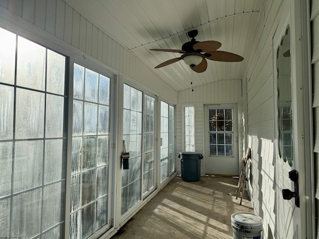 unfurnished sunroom with ceiling fan and lofted ceiling