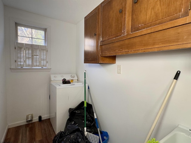 laundry room featuring dark hardwood / wood-style floors, cabinets, and washer / clothes dryer