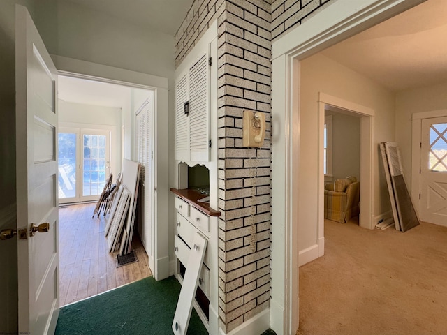 hallway with carpet floors