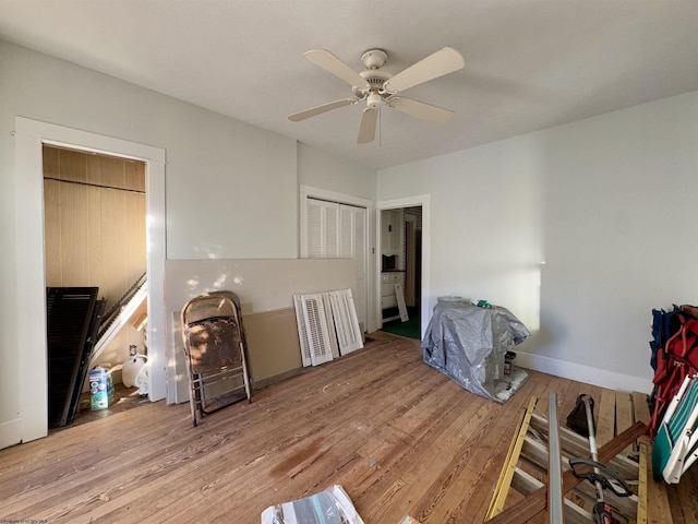 bedroom with a closet, light hardwood / wood-style flooring, and ceiling fan