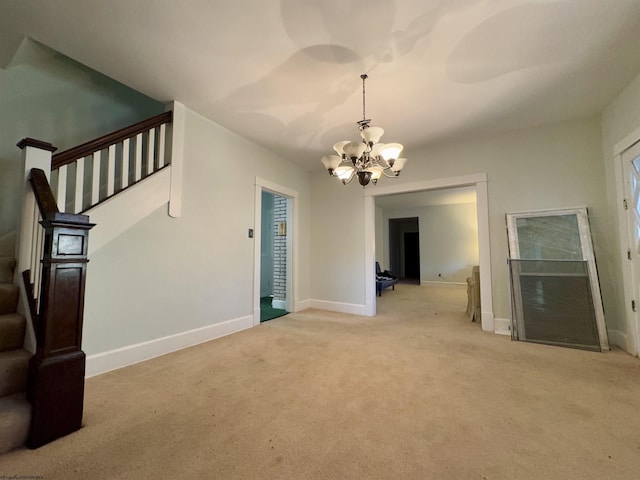 unfurnished living room with a chandelier and light carpet