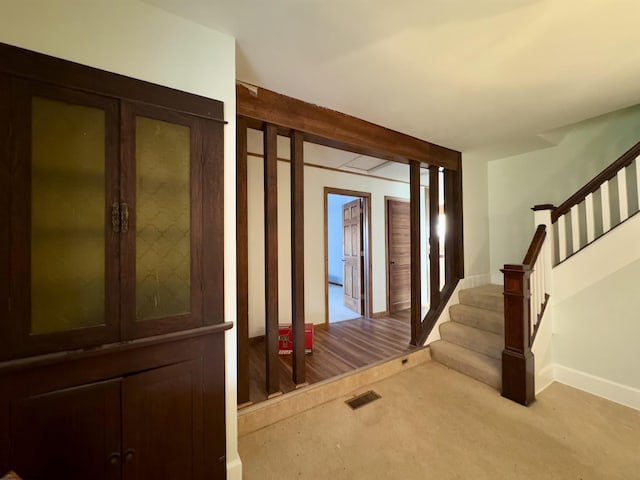 foyer entrance featuring light colored carpet