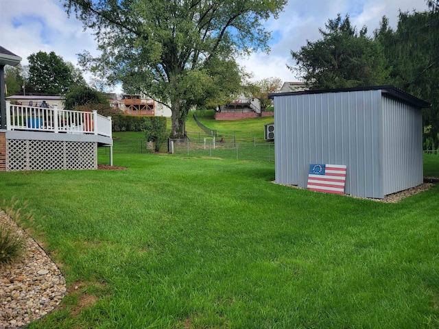 view of yard with a storage unit and a wooden deck