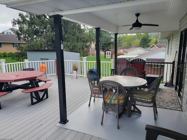 deck with ceiling fan and a storage unit