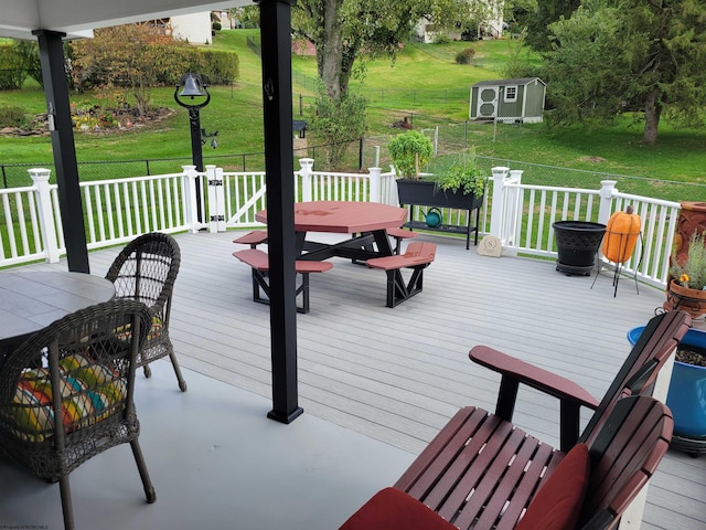 deck featuring a yard and a shed