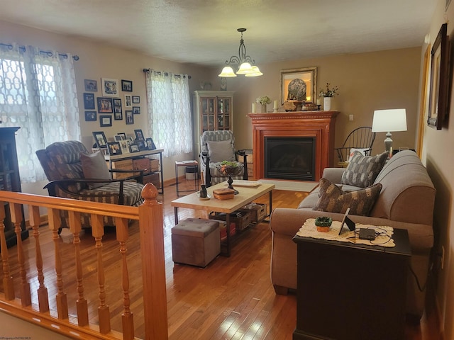 living room featuring hardwood / wood-style flooring, a wealth of natural light, and a notable chandelier