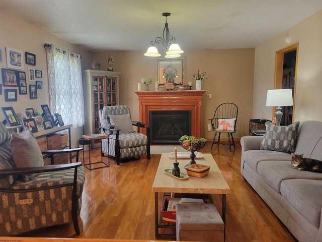 living room featuring light hardwood / wood-style flooring and an inviting chandelier