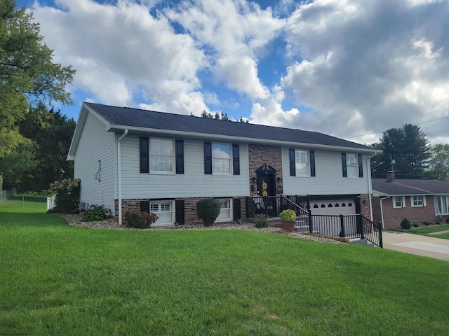 bi-level home with a front lawn and a garage