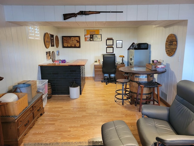 office featuring wood walls and light hardwood / wood-style floors