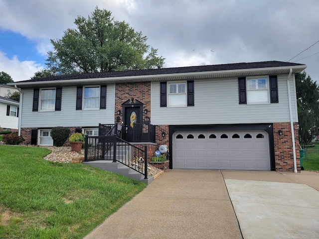 raised ranch featuring a front lawn and a garage