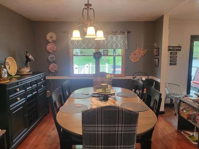 dining space featuring light hardwood / wood-style floors and an inviting chandelier