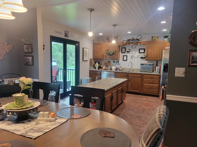 kitchen featuring light stone counters, wood ceiling, stainless steel appliances, pendant lighting, and a kitchen island