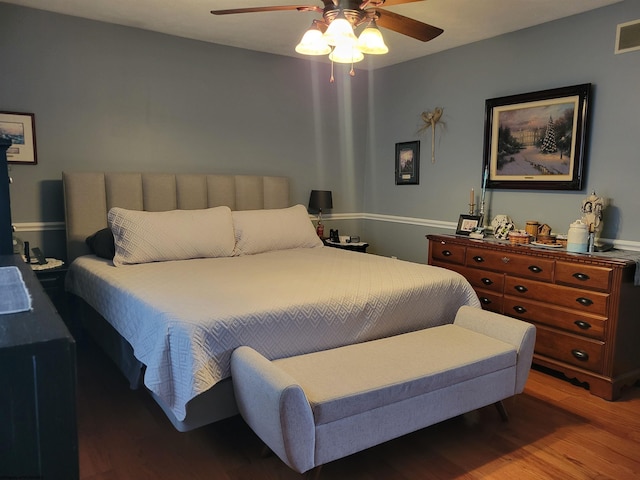 bedroom with hardwood / wood-style flooring and ceiling fan