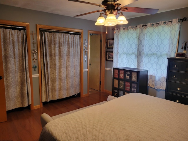 bedroom with ceiling fan and dark wood-type flooring