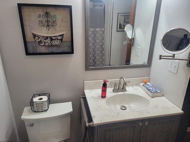 bathroom featuring vanity and toilet