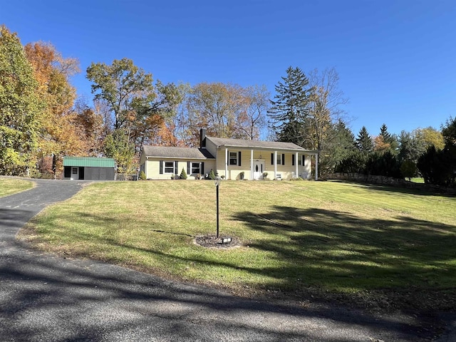 view of front of house with a front yard and a porch