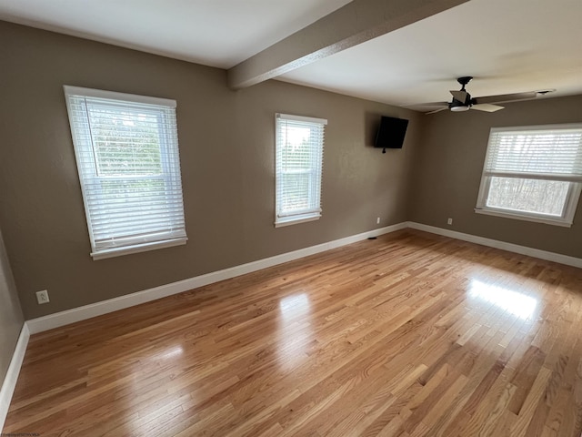 spare room with ceiling fan, plenty of natural light, and light hardwood / wood-style flooring