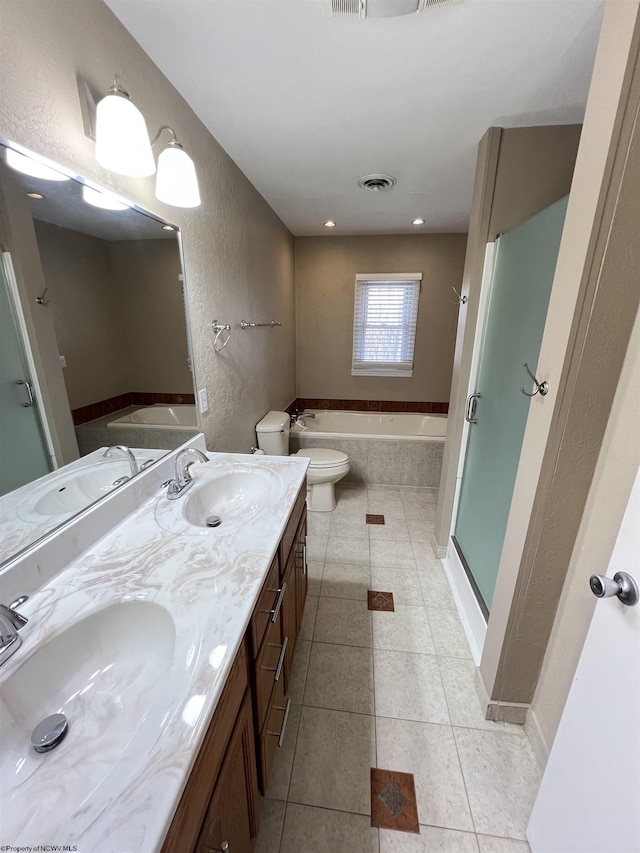 full bathroom with tile patterned flooring, vanity, toilet, and independent shower and bath