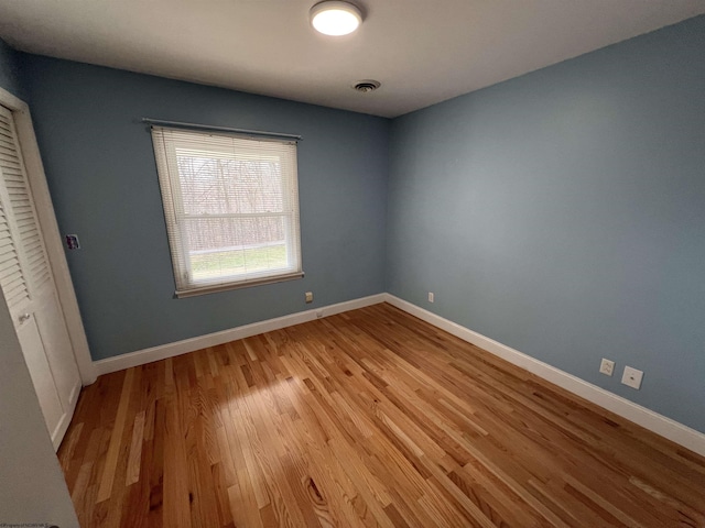 unfurnished bedroom featuring a closet and light hardwood / wood-style flooring