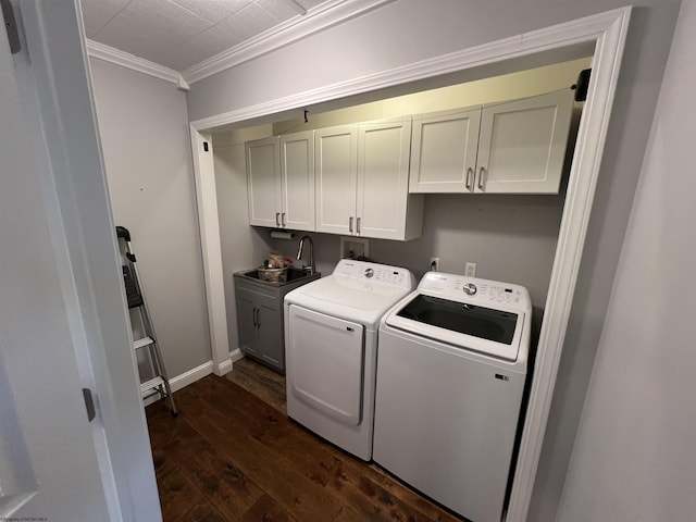 clothes washing area with cabinets, crown molding, dark wood-type flooring, sink, and separate washer and dryer