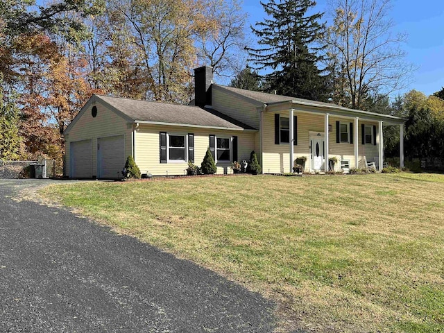 view of front of home with a porch, a garage, and a front lawn