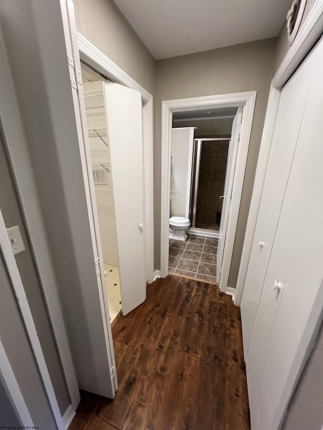 corridor with dark hardwood / wood-style flooring