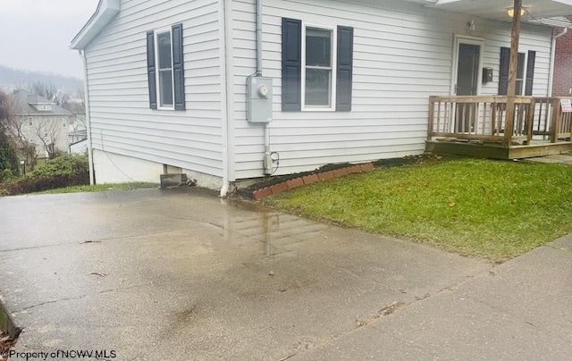 view of side of home with a lawn