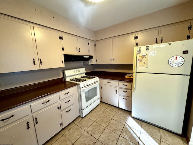 kitchen featuring white cabinets, light tile patterned flooring, and white appliances