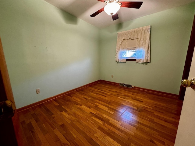 spare room with hardwood / wood-style flooring and ceiling fan