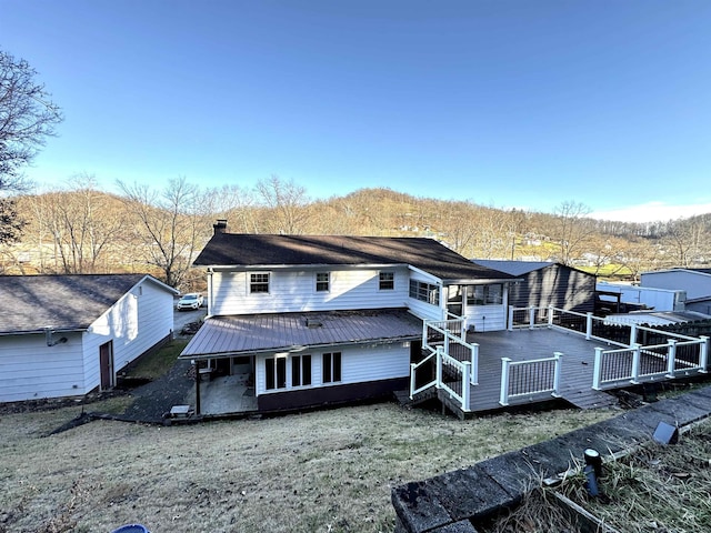 back of house featuring a wooden deck