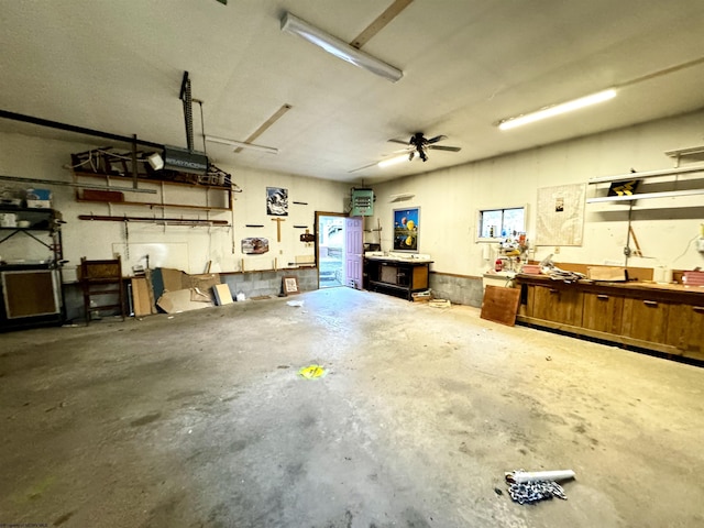 garage with a workshop area and ceiling fan