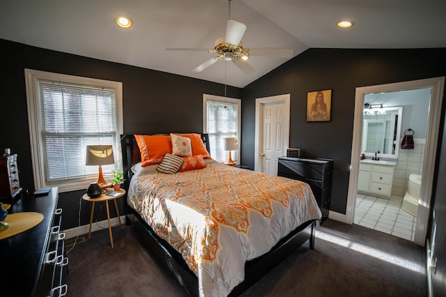 tiled bedroom with baseboards, recessed lighting, ceiling fan, vaulted ceiling, and connected bathroom