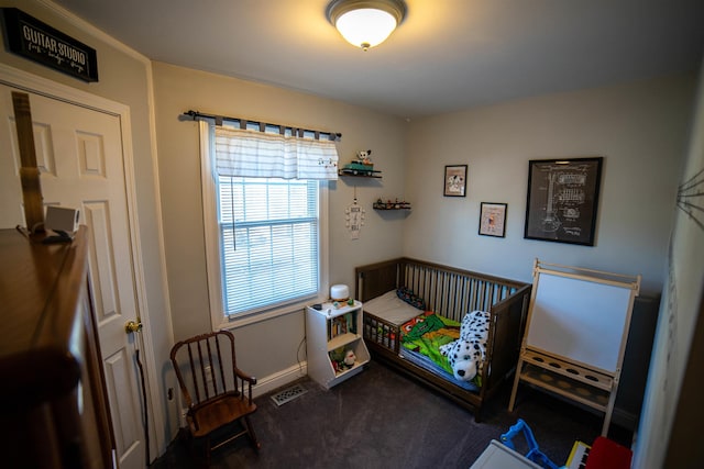 carpeted bedroom featuring visible vents and baseboards