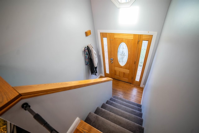 foyer entrance with stairway and wood finished floors